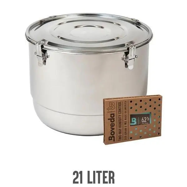 The CVault Humidity Control Airtight Metal Smell Proof Container (21L) by CVault sits beside a Boveda packet, ideal for maintaining airtight storage and odor control.